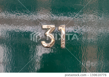 Brass number thirty one on glossy green door Brass number thirty one on glossy green door 130610778
