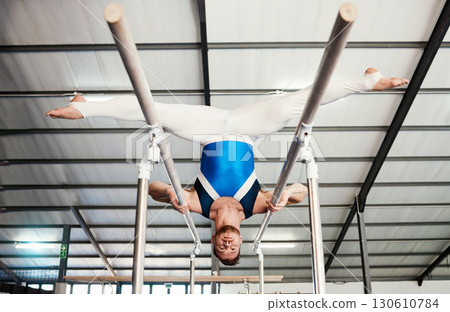Gymnast man, bars and exercise with balance, strong body and focus for sports, vision and split legs in air. Gymnastics, athlete and training with muscle development, workout and low angle at gym Gymnast man, bars and exercise with balance, strong body and focus for sports, vision and split legs in air. Gymnastics, athlete and training with muscle development, workout and low angle at gym 130610784