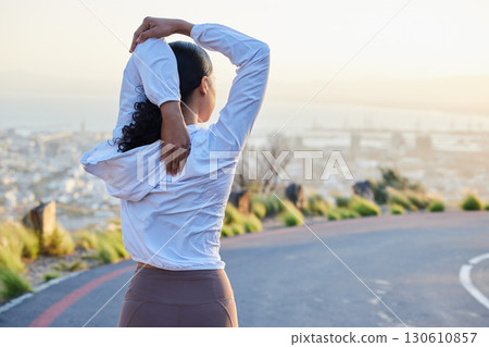 Fitness, stretching and arm by woman rear view in road for running, training and exercise at sunset. Runner, stretch and back of girl at sunrise for cardio, marathon or outdoor practice run workout 130610857