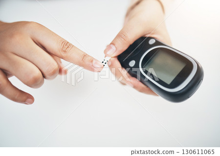 Diabetes, hands of black woman and blood test strip on finger, healthcare and medicine in home. Health, innovation and technology, diabetic person with digital hand glucometer checking glucose level. 130611065
