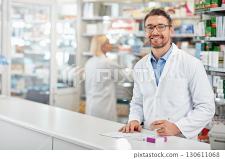 Portrait of happy pharmacist man with pharmacy services, medicine advice and product trust at shop, retail counter. Inventory, stock help desk and medical professional worker, person or doctor smile Portrait of happy pharmacist man with pharmacy services, medicine advice and product trust at shop, retail counter. Inventory, stock help desk and medical professional worker, person or doctor smile 130611068