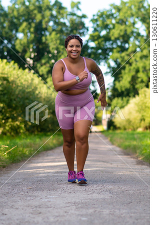 Curvy woman in activewear running fitness training 130611220