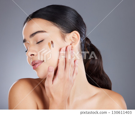 Beauty, foundation and relax face of model test skincare product for self care, anti aging or wellness. Facial healthcare, spa salon girl and happy woman with makeup cosmetics on studio background Beauty, foundation and relax face of model test skincare product for self care, anti aging or wellness. Facial healthcare, spa salon girl and happy woman with makeup cosmetics on studio background 130611403