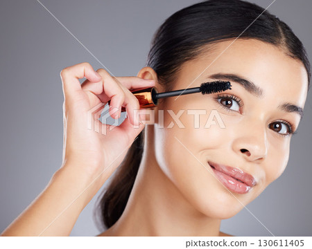 Portrait, eyelash and brush for makeup, mascara and beauty with girl with grey studio background. Face, eyes and salon equipment for grooming routine, wellness and confidence with brows and cosmetics Portrait, eyelash and brush for makeup, mascara and beauty with girl with grey studio background. Face, eyes and salon equipment for grooming routine, wellness and confidence with brows and cosmetics 130611405
