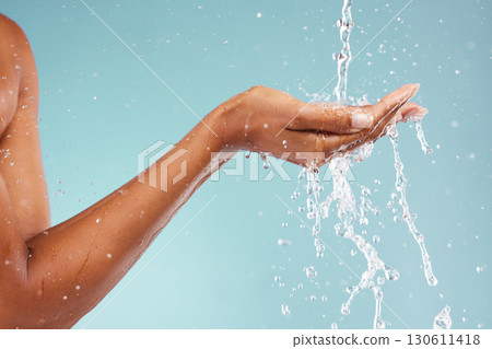Sustainability, ecology and hand of a woman with water isolated on blue background in a studio. Environment, clean energy and person with a splash to recycle liquid for agriculture change on backdrop Sustainability, ecology and hand of a woman with water isolated on blue background in a studio. Environment, clean energy and person with a splash to recycle liquid for agriculture change on backdrop 130611418