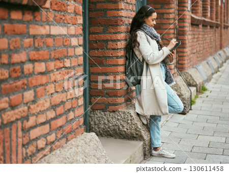 Woman, student and tablet relaxing on brick wall writing, design or doing research in the city. Female university learner working on touchscreen with wireless pen or tech in a urban town Woman, student and tablet relaxing on brick wall writing, design or doing research in the city. Female university learner working on touchscreen with wireless pen or tech in a urban town 130611458