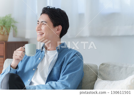 Man having a drink at home 130611501