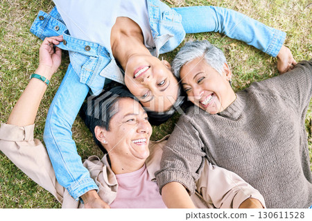 Park, friends relax and top view of women bonding, caring and enjoying quality time together. Peace, freedom and happy group of retired senior females lying on grass talking, chatting and having fun. 130611528