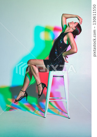 Fashion, mockup or kaleidoscope and a woman in studio isolated on a white background with color special effects. Neon, creative and chair with an attractive young female model on blank space Fashion, mockup or kaleidoscope and a woman in studio isolated on a white background with color special effects. Neon, creative and chair with an attractive young female model on blank space 130611550