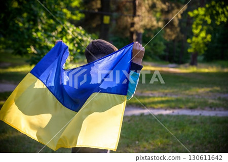 Pray for Ukraine. boy with Ukrainian flag running the summer par 130611642