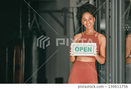 Fitness, portrait or personal trainer at gym with an open sign for workout exercises or training. Manager, happy or healthy black woman with a friendly smile holding a board to welcome exercising Fitness, portrait or personal trainer at gym with an open sign for workout exercises or training. Manager, happy or healthy black woman with a friendly smile holding a board to welcome exercising 130611756