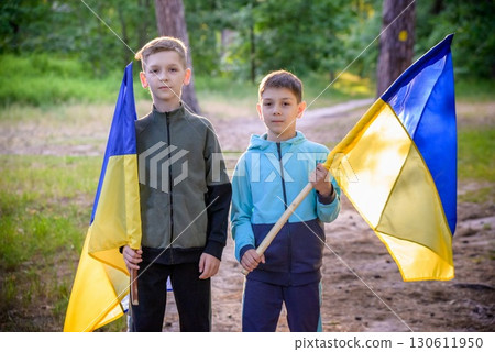 flags of Ukraine in hands of two boys. Children hold Ukrainian f 130611950