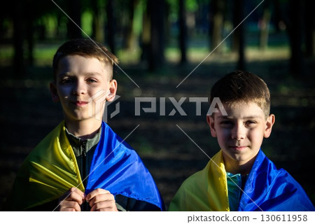 flags of Ukraine in hands of two boys. Children hold Ukrainian f 130611958