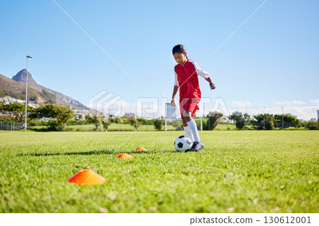 Football girl kid, training and grass for fitness, speed or balance with sport talent development, control and speed. Female child, fast football dribbling or motivation mindset on field in Cape Town 130612001