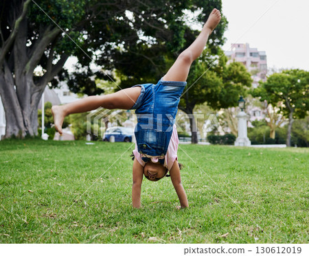 Cartwheel, child and outdoor park fun of a girl in summer with freedom and happiness. Fun, happy and holiday play of a young kid on green grass in nature on a morning with blue sky and smiling Cartwheel, child and outdoor park fun of a girl in summer with freedom and happiness. Fun, happy and holiday play of a young kid on green grass in nature on a morning with blue sky and smiling 130612019