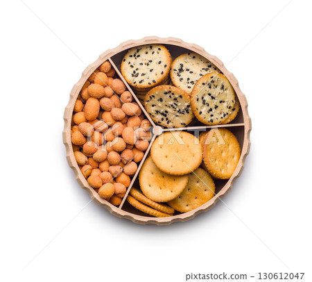 Various salty snacks in a round bowl isolated on white background. Various salty snacks in a round bowl isolated on white background. 130612047