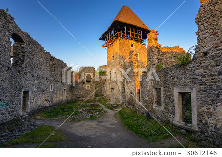 nevytske, ukraine - 19 may, 2018: castle with tower and stone wall at sunset. medieval fortress architecture of ukraine. travel destination and heritage site of transcarpathia 130612146