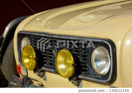 uzhgorod, ukraine - 31 oct 2021: front view of a beige oldtimer renault 4. outdoor closeup shot on a sunny day 130612148