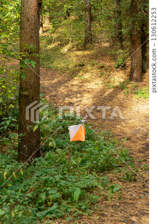 Orienteering. Control point Prism and electric composter for orienteering in the autumn forest. Orienteering. Control point Prism and electric composter for orienteering in the autumn forest. 130612253