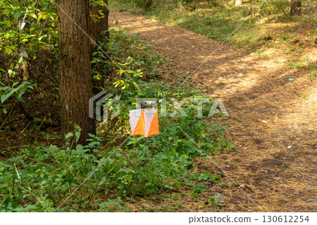 Orienteering. Control point Prism and electric composter for orienteering in the autumn forest. Orienteering. Control point Prism and electric composter for orienteering in the autumn forest. 130612254