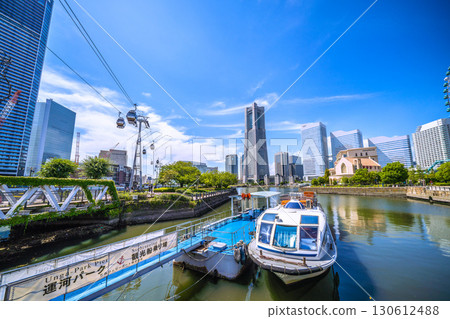 Yokohama cityscape, Japan, September 6th. View of Yokohama Landmark Tower and the Canal Park sightseeing boat dock. Yokohama cityscape, Japan, September 6th. View of Yokohama Landmark Tower and the Canal Park sightseeing boat dock. 130612488
