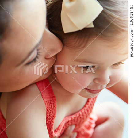 Mother kissing her girl baby on her cheek while playing, bonding and spending time together. Happy, smile and girl infant child sitting with her mom in their modern family home with love with care. Mother kissing her girl baby on her cheek while playing, bonding and spending time together. Happy, smile and girl infant child sitting with her mom in their modern family home with love with care. 130612489