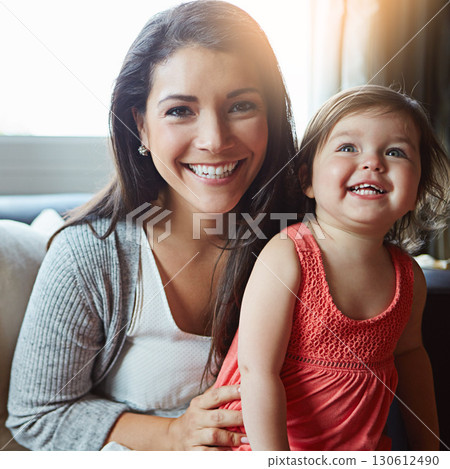 Mother, child and happy portrait together on sofa in living room for relax love bonding, fun and support care. Mom smile, excited little daughter and quality time happiness on couch in family home 130612490