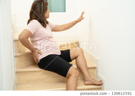 Asian lady fall down the stairs and pain at hip and waist because slippery surfaces. 130612591