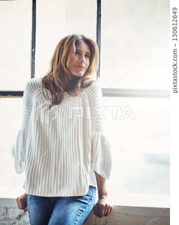Woman, thinking and relax against window in her home, calm and content while daydreaming on mockup. Contemplating, girl and confident, beautiful and peaceful female satisfied, thoughtful and relaxed 130612649