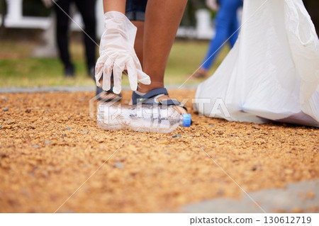 Volunteer hands, bottle and woman cleaning garbage, pollution or trash waste for environment support. Community recycling, NGO charity and eco friendly people help with nature park plastic clean up 130612719