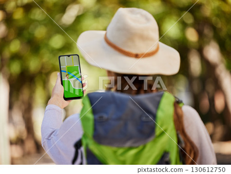 GPS, direction and woman hiking in a forest for exercise, adventure or wellness in nature. Navigation app, phone and female hiker trekking on an outdoor trail in the woods alone with a mobile map. GPS, direction and woman hiking in a forest for exercise, adventure or wellness in nature. Navigation app, phone and female hiker trekking on an outdoor trail in the woods alone with a mobile map. 130612750