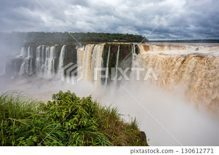 Powerful Iguazu Falls, one of the world's most impressive waterfalls. Argentina side. Brazilian wilderness landscape. 130612771