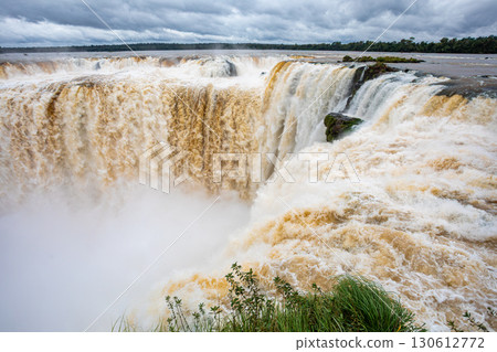 Powerful Iguazu Falls, one of the world's most impressive waterfalls. Argentina side. Brazilian wilderness landscape. 130612772