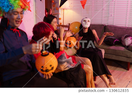 Dinner and group of people celebrating together at Halloween party. 130612835