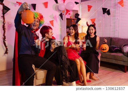 Dinner and group of people celebrating together at Halloween party. 130612837