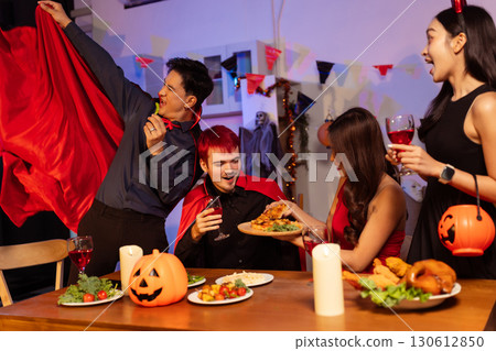 Dinner and group of people celebrating together at Halloween party. 130612850