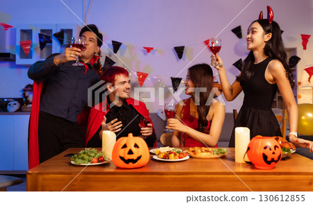 Dinner and group of people celebrating together at Halloween party. 130612855