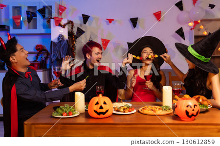 Dinner and group of people celebrating together at Halloween party. 130612859