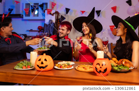 Dinner and group of people celebrating together at Halloween party. 130612861
