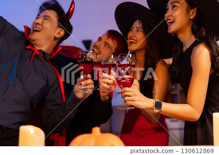 Dinner and group of people celebrating together at Halloween party. 130612869