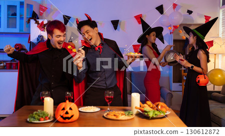 Dinner and group of people celebrating together at Halloween party. 130612872