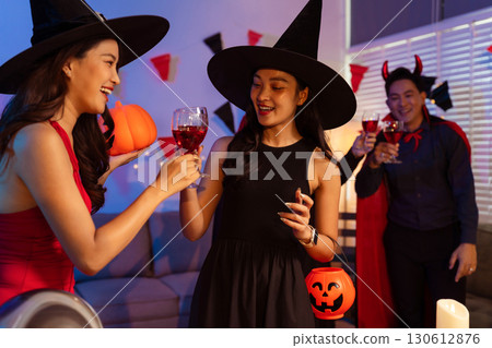 Dinner and group of people celebrating together at Halloween party. Dinner and group of people celebrating together at Halloween party. 130612876