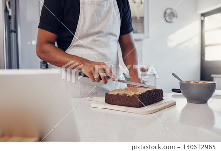 Decoration, baking and man with a cake in the kitchen for birthday food, dessert and pudding. Cooking, preparation and baker learning to decorate a sweet treat for a celebration on a table in a house 130612965