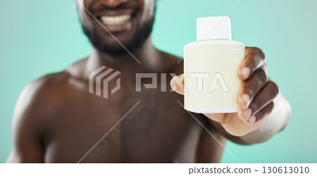 Black man, hands and skincare cosmetics, product or serum bottle for facial or body treatment against studio background. Hand of African American male holding solution for skin, advertising or brand 130613010