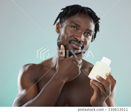 Skincare, black man and cream for cosmetics, wellness and natural beauty with guy on grey studio background. African American male, confident person and gentleman with lotion for smooth or clear skin Skincare, black man and cream for cosmetics, wellness and natural beauty with guy on grey studio background. African American male, confident person and gentleman with lotion for smooth or clear skin 130613011