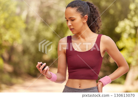 Fitness, woman and checking stop watch for running exercise, workout or training in the nature outdoors. Active female runner looking at time for monitoring run, steps or cardio performance tracking Fitness, woman and checking stop watch for running exercise, workout or training in the nature outdoors. Active female runner looking at time for monitoring run, steps or cardio performance tracking 130613070
