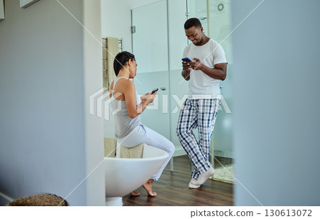 Social media, app and black couple on phone in the bathroom for news, website and chat. Communication, happy and African man and woman reading funny story on the internet on a mobile in the morning Social media, app and black couple on phone in the bathroom for news, website and chat. Communication, happy and African man and woman reading funny story on the internet on a mobile in the morning 130613072
