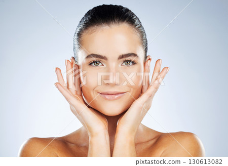 Beauty, woman and clean skincare portrait with smile for hydration, self care and natural glow of people. Dermatology, aesthetic and healthy skin of person on isolated gray studio background. Beauty, woman and clean skincare portrait with smile for hydration, self care and natural glow of people. Dermatology, aesthetic and healthy skin of person on isolated gray studio background. 130613082