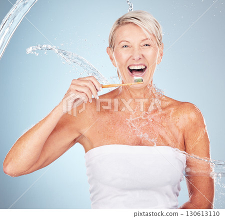 Woman, studio and toothbrush with water splash, smile or portrait for mouth wellness by blue background. Happy senior model, organic wood brush or dental clean for healthy teeth in self care process 130613110