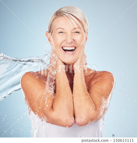 Portrait, senior woman and water splash for dermatology, cosmetics and skincare on grey studio background. Face, mature female or elderly lady wet, smile or cleaning for hygiene, healthy or soft skin Portrait, senior woman and water splash for dermatology, cosmetics and skincare on grey studio background. Face, mature female or elderly lady wet, smile or cleaning for hygiene, healthy or soft skin 130613111